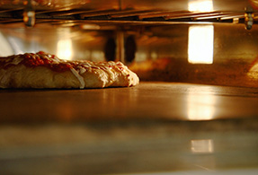 Roma pizza in oven.